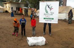 Palestinians in Syria Relief and Development Association distributes heating materials in Muzayrib