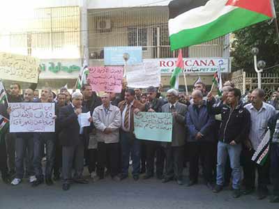 Displaced residents of the Yarmouk camp in Lebanon sit-in in front of the UNRWA Office in Tripoli.