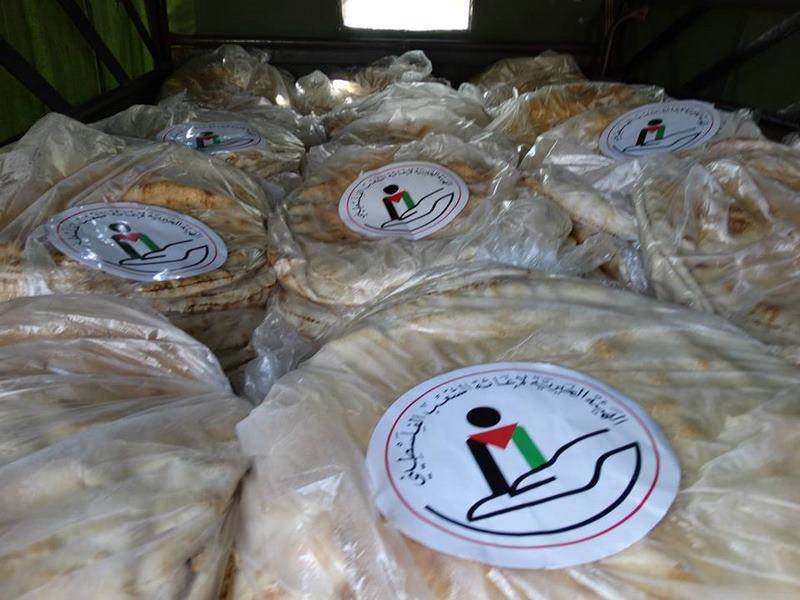 The Charity Committee for the Relief of Palestinian People Distributes Bread to the Besieged Families in the Yarmouk Camp