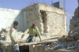 Amid the absence of aid, residents of Handarat camp rebuild their houses at their own expense