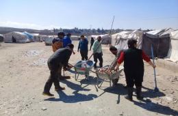 Palestinian Volunteers Engaged in Relief Mission in Deir Ballout Camp 