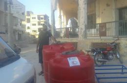 Plastic Water Tanks Distributed in Syria’s Impoverished Daraa Camp for Palestinian Refugee